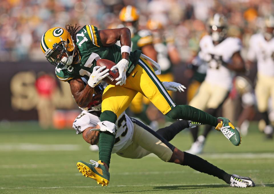 Davante Adams (17) of the Green Bay Packers makes a catch against Marshon Lattimore of the New Orleans Saints during the first half at TIAA Bank Field on September 12, 2021 in Jacksonville, Florida.