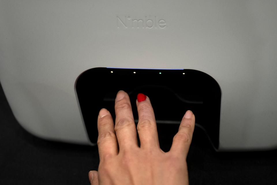 A person uses Nimble Beauty's Nimble Device to paint their nail during Pepcom's Digital Experience at the The Mirage resort during the Consumer Electronics Show (CES) in Las Vegas, Nevada on January 8, 2024.