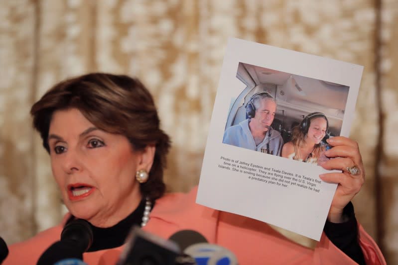 Attorney Gloria Allred holds a photograph of her client, Teala Davies with Jeffrey Epstein as she speaks in regards to a lawsuit alleging that Davies was assaulted by Jeffrey Epstein for two years during a press conference in New York City