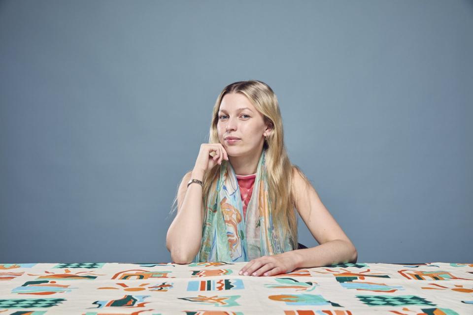 a designer with a silk fabric on a table