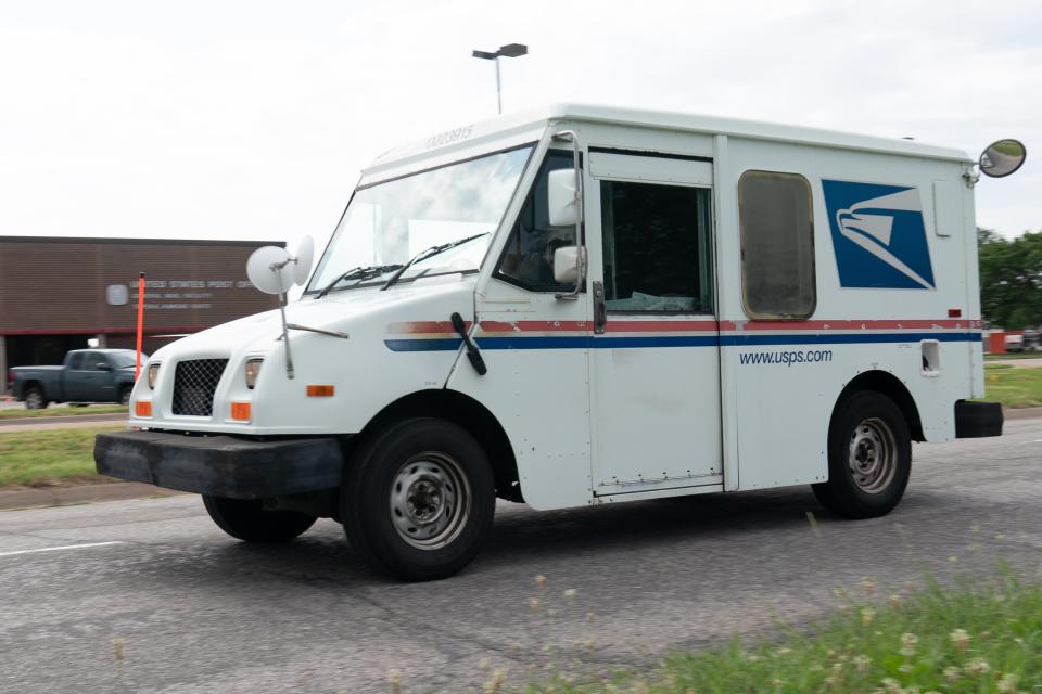 A USPS mail delivery vehicle drives past the general mail facility at 1410 N.W. Gage Blvd. Friday morning.