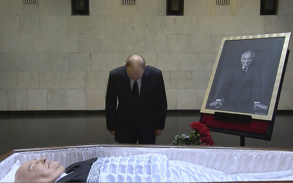 In this image taken from video provided by the Russian pool television on Thursday, Sept. 1, 2022, Russian President Vladimir Putin pays his last respect near the coffin of former Soviet President Mikhail Gorbachev at the Central Clinical Hospital in Moscow Russia. (Russian pool via AP)