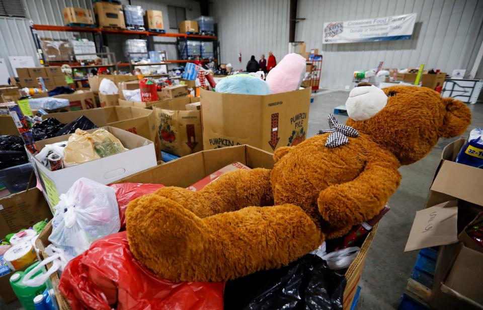 A giant teddy bear sits in the Crosslines warehouse during Share Your Christmas distribution on Friday, Dec. 16, 2022.