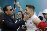 Former Major League Baseball star Alex Rodriguez, left, greets San Francisco 49ers defensive end Nick Bosa and before the NFL Super Bowl 54 football game between the 49ers and Kansas City Chiefs Sunday, Feb. 2, 2020, in Miami Gardens, Fla. (AP Photo/John Bazemore)