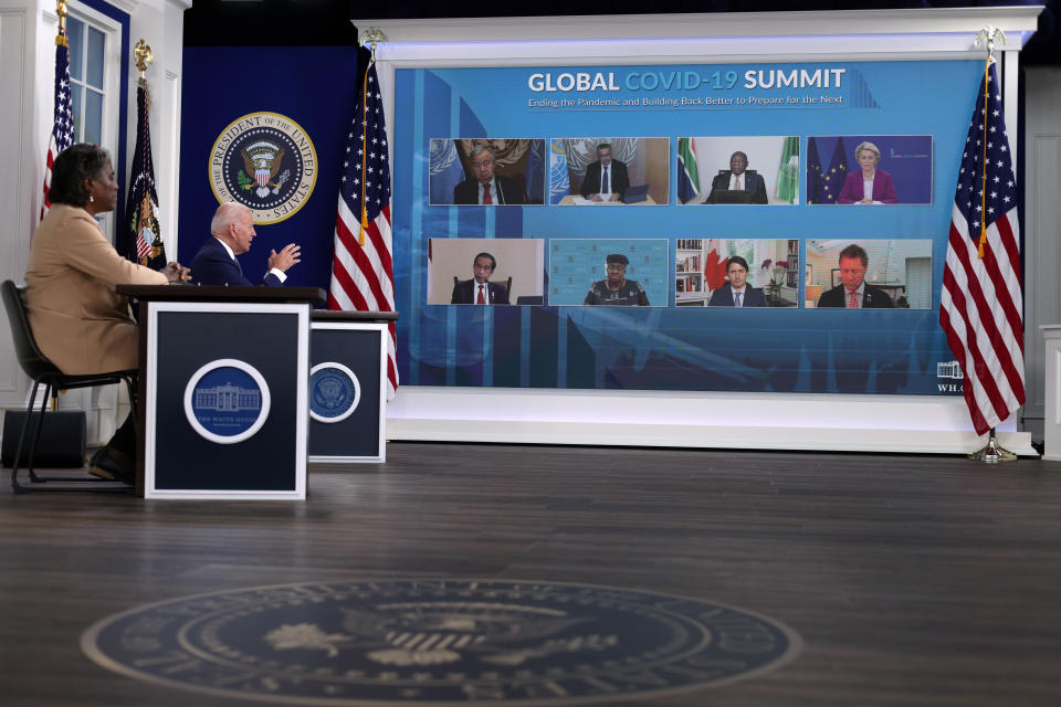 At the White House, President Biden and the U.S. ambassador to the U.N., Linda Thomas-Greenfield, left, take part in a virtual U.N. General Assembly COVID summit Wednesday. 