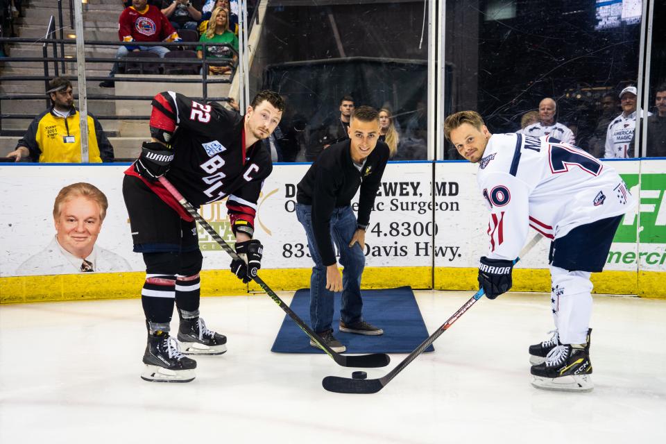 A member of the Blue Angels staff drops the puck during a ceremonial puck drop during a previous Pensacola Ice Flyers game against the Evansville Thunderbolts.