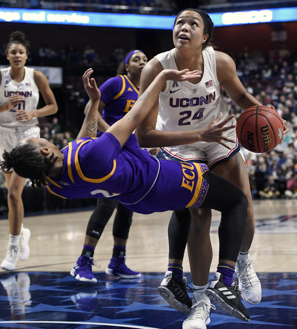 Connecticut's Napheesa Collier fouls East Carolina's Lashonda Monk, left, during the first half of an NCAA college basketball game in the American Athletic Conference tournament quarterfinals, Saturday, March 9, 2019, at Mohegan Sun Arena in Uncasville, Conn. (AP Photo/Jessica Hill)