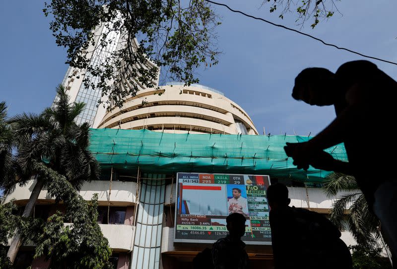 People watch results for India's general elections on a screen outside the Bombay Stock Exchange (BSE) in Mumbai