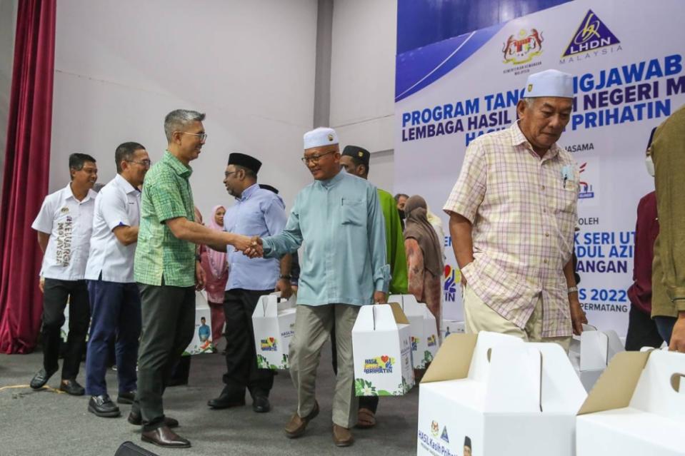 Finance Minister Datuk Seri Tengku Zafrul Abdul Aziz (centre) greets recipients during the LHDNM corporate social responsibility (CSR) programme at Dewan Dato Penggawa Permatang in Kuala Selangor, August 14, 2022. — Picture by Yusof Mat Isa