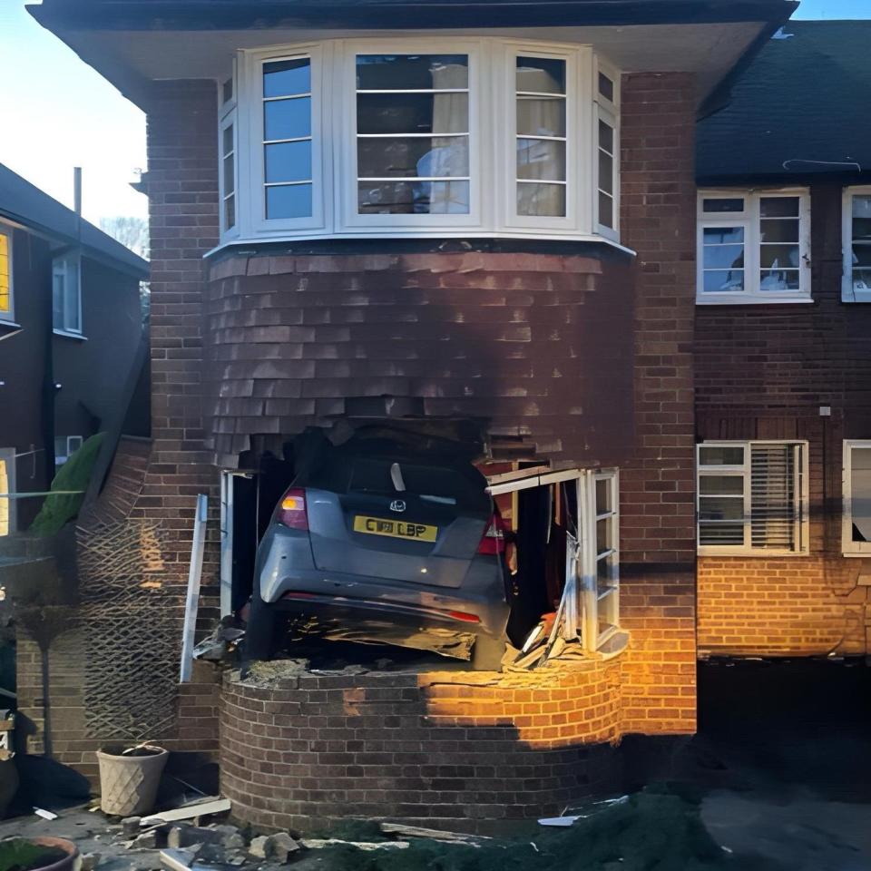 A neighbour thought the crash may have happened after the driver attempted to park but pressed the accelerator