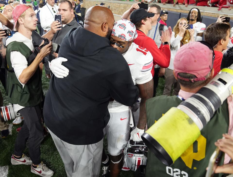 Sep 23, 2023; South Bend, Indiana, USA; Ohio State Buckeyes running back Chip Trayanum (19) hugs a support staffer after scoring the game winning touchdown and beating beating Notre Dame Fighting Irish 17-14 at Notre Dame Stadium.