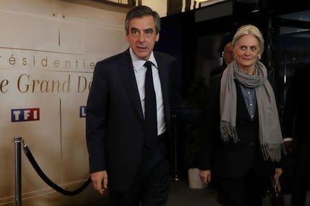 Francois Fillon, former French prime minister, member of The Republicans political party and 2017 presidential election candidate of the French centre-right, and his wife Penelope arrive for a debate organised by French private TV channel TF1 in Aubervilliers, outside Paris, France, March 20, 2017. REUTERS/Patrick Kovarik/Pool