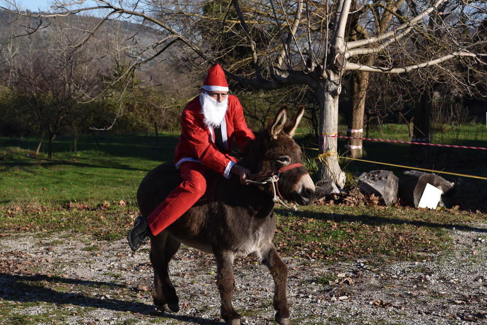 Santa sits on his donkey at Equestrian Club Vranac's Santa Claus donkey race in Capljina, Bosnia and Herzegovina, on Dec. 18.