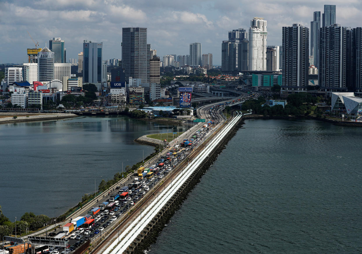 Commuters take the Woodlands Causeway to Singapore from Johor a day before Malaysia imposes a lockdown on travel due to the coronavirus outbreak in Singapore March 17, 2020.