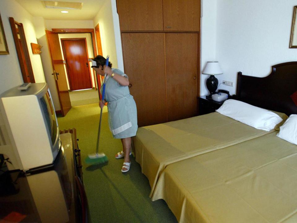 A maid cleans a room (Getty)