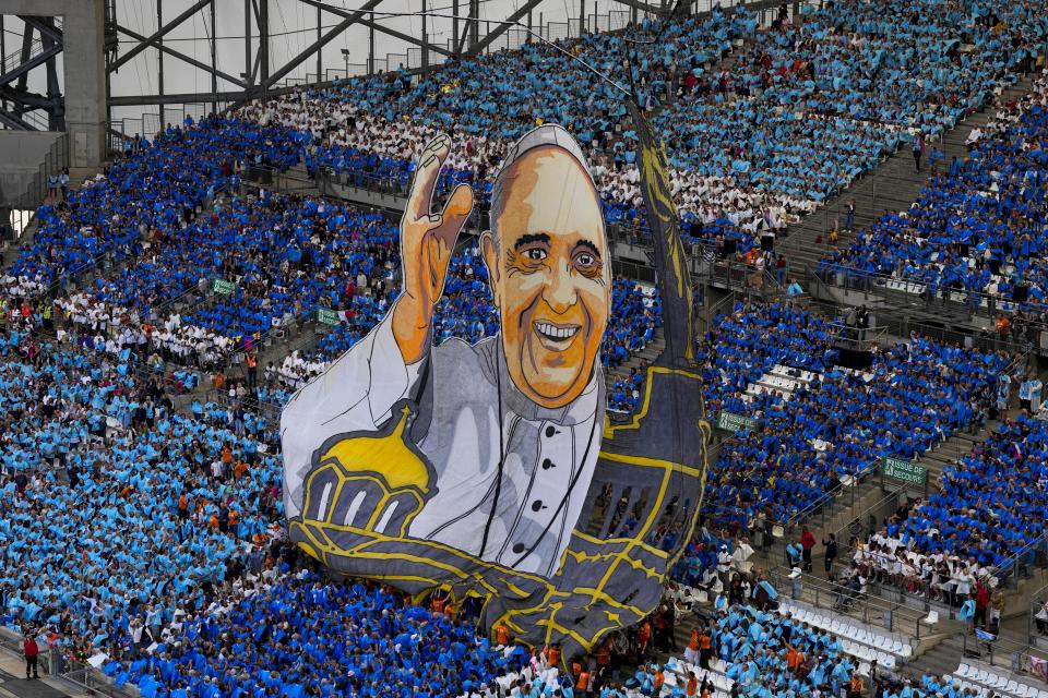 A giant image of Pope Francis is lifted as Pope Francis arrives at the "Velodrome Stadium", in Marseille, France, to celebrate mass, Saturday, Sept. 23, 2023. Francis, during a two-day visit, will join Catholic bishops from the Mediterranean region on discussions that will largely focus on migration. (AP Photo/Pavel Golovkin)