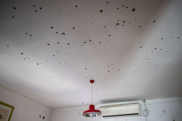 Shrapnel holes are seen in the ceiling of a partially destroyed house in Kissufim, Israel, where Hamas attacked on Oct. 7.