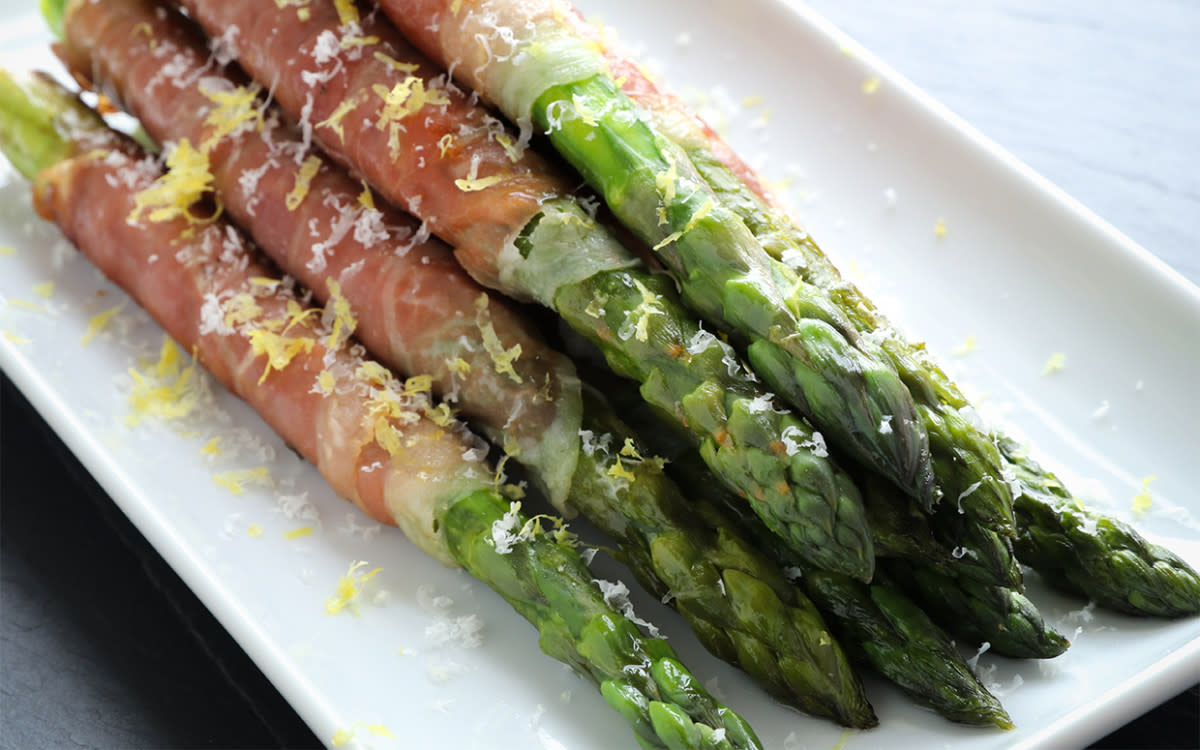 <p>Jon Ashton</p><p>This easy recipe from <em>Parade</em> chef Jon Ashton adds a burst of tangy lemon to the salty, crunchy spears. </p><p><strong>Get the recipe: <a href="https://parade.com/671999/jonashton/prosciutto-wrapped-asparagus/" rel="nofollow noopener" target="_blank" data-ylk="slk:Prosciutto-Wrapped Asparagus;elm:context_link;itc:0;sec:content-canvas" class="link rapid-noclick-resp">Prosciutto-Wrapped Asparagus</a> </strong></p><p><strong>Related: <a href="https://parade.com/1022051/parade/easter-recipes/" rel="nofollow noopener" target="_blank" data-ylk="slk:101 Best Easter Recipes;elm:context_link;itc:0;sec:content-canvas" class="link rapid-noclick-resp">101 Best Easter Recipes</a></strong></p>