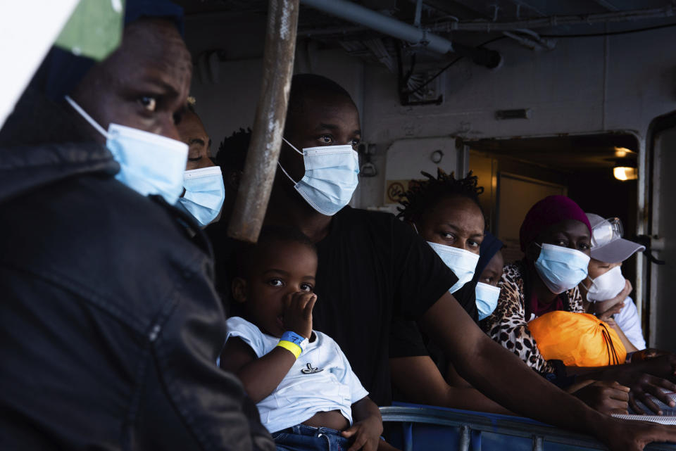 Some of the 353 migrants rescued by Sea-Watch 4 wait to board the quarantine Ferry Gnv Allegra, in front of the port of Palermo, Italy, Wednesday, Sept. 2, 2020. (Chris Grodotzki/Sea-Watch.org via AP)