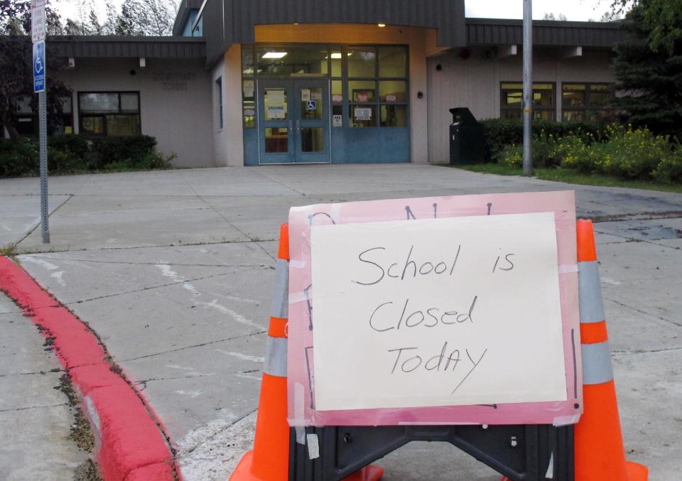 A sign at an elementary school in east Anchorage, Alaska, states that school has been canceled on Wednesday, Sept. 5, 2012. A massive windstorm uprooted trees, knocked out power and closed schools in Anchorage. (AP Photo/Mark Thiessen)