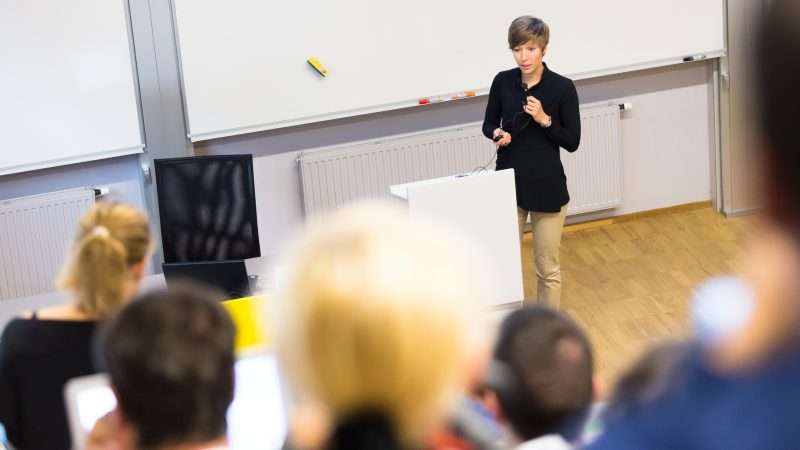 A professor instructs a college classroom.