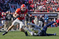 Georgia tight end Brock Bowers (19) breaks away from Charleston Southern defensive lineman Elijah Harper (17) after a catch in the first half of an NCAA college football game Saturday, Nov. 20, 2021, in Athens, Ga. (AP Photo/John Bazemore)