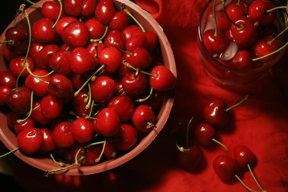 A bowl filled with ruby red tart cherries.