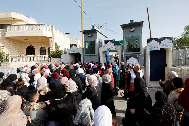 Palestinians make their way to attend the first Friday prayers of Ramadan through an Israeli checkpoint, in Bethlehem