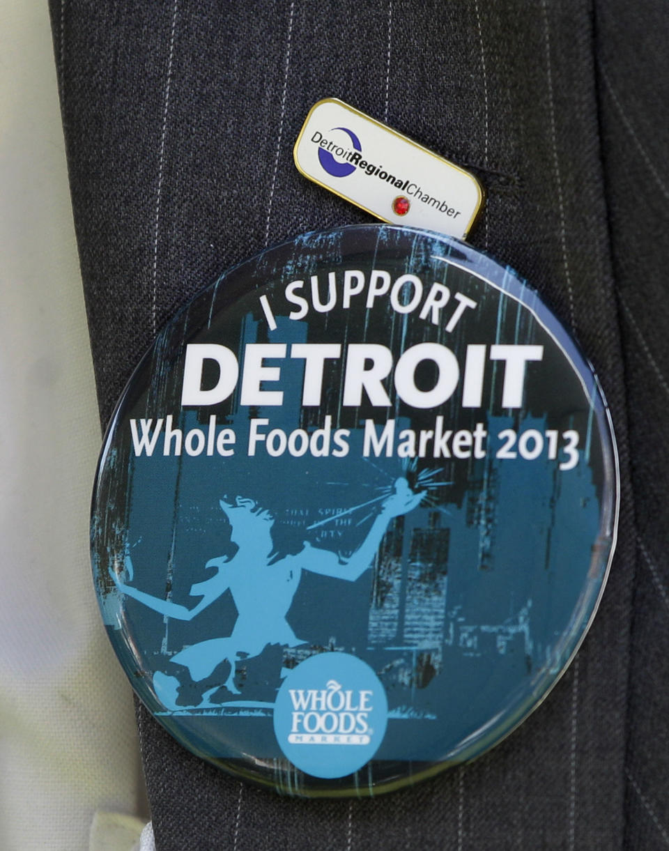 A supporter of Whole Foods Market wears a button during a ground breaking ceremony for the retailer in Detroit, Monday, May 14, 2012. The Austin, Texas-based retailer plans to open a 20,000-square-foot supermarket with about 75 employees next year. The company began looking at Midtown in 2010. Midtown is one of the few areas in the city that is seeing population growth. (AP Photo/Carlos Osorio)