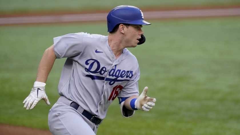 Los Angeles Dodgers' Will Smith runs to first against the Atlanta Braves during the first inning.