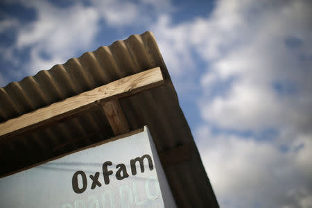 An Oxfam sign is seen on a kiosk that was used to distribute water in Corail, a camp for displaced people of the 2010 earthquake, on the outskirts of Port-au-Prince, Haiti, February 13, 2018. REUTERS/Andres Martinez Casares