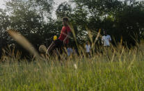 Youths play soccer on an old baseball field in the Santa Fe municipality of Guanabacoa east of Havana, Cuba, Saturday, Oct. 15, 2022. Coaches who were recently trained by international FIFA officials would like to see Cuba once again rise in the standings. (AP Photo/Ramon Espinosa)