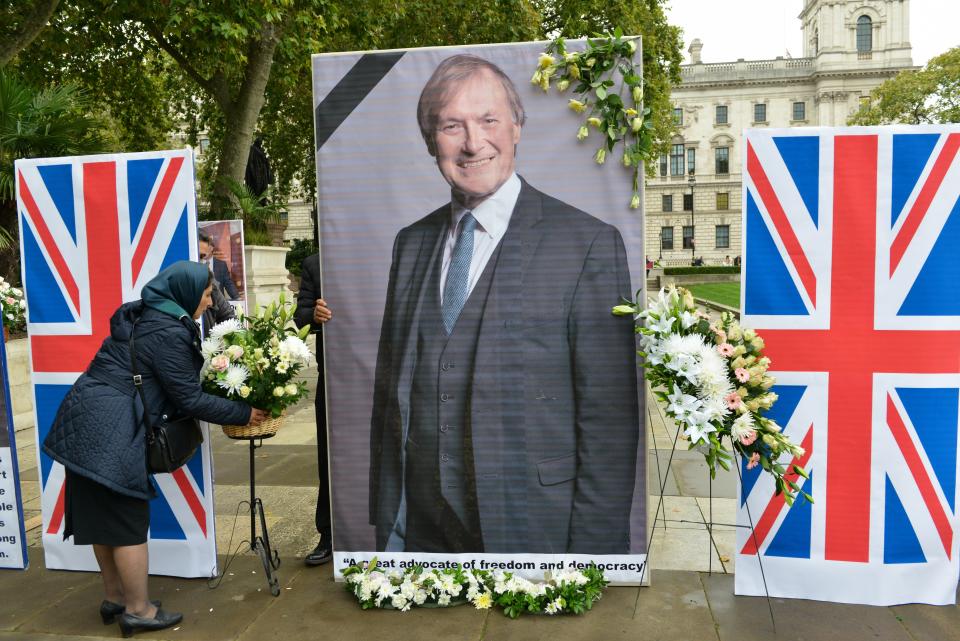 Member of the Anglo-Iranian community pays tribute to Sir David Amess MP by laying flowers at Parliament Square.. Members of the Anglo-Iranian communities, supporters of the National Council of Resistance of Iran (NCRI) and British Committee for Iranian Freedom (BCFIF), held a memorial service opposite the UK Parliament to pay tribute to Sir David Amess MP by laying flowers. (Photo by Thomas Krych / SOPA Images/Sipa USA)