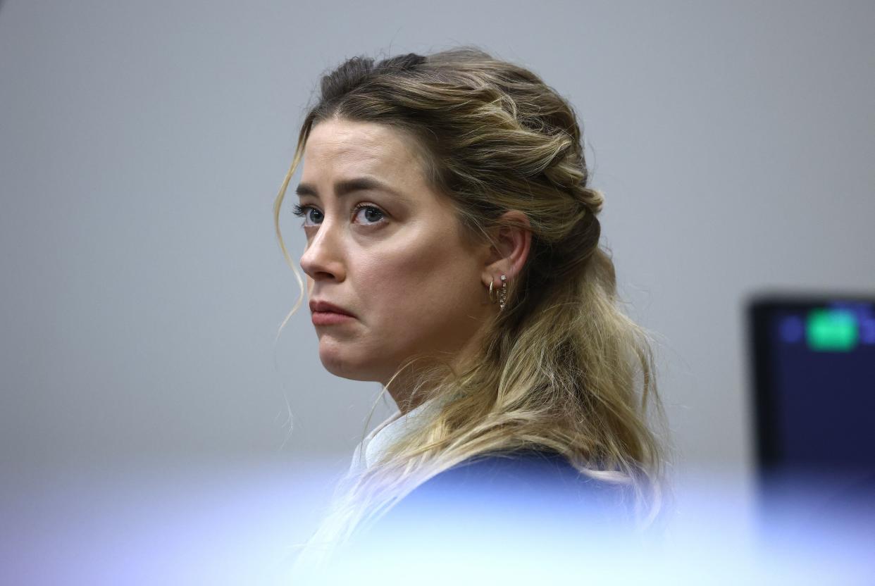 Amber Heard listens to Johnny Depp's testimony in court on April 21, 2022.