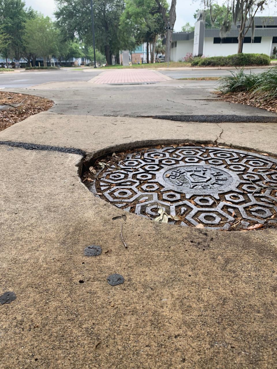 A manhole cover in downtown Gainesville where Doug Haugen, 66, was injured while riding an electric scooter, fracturing both arms.