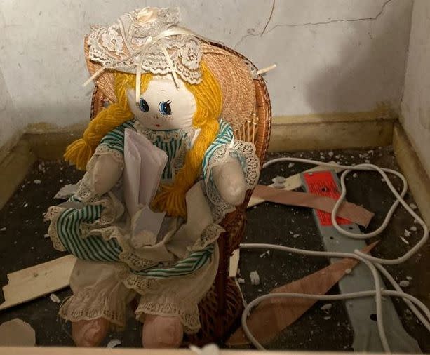 The doll that was hidden in the wall.