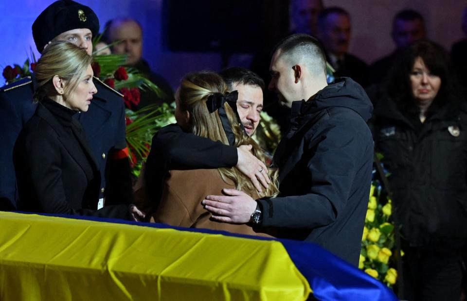 Ukrainian president Volodymyr Zelensky and his wife Olena offer relatives their condolences during the funeral ceremony of Ukrainian interior minister Denys Monastyrsky (AFP)