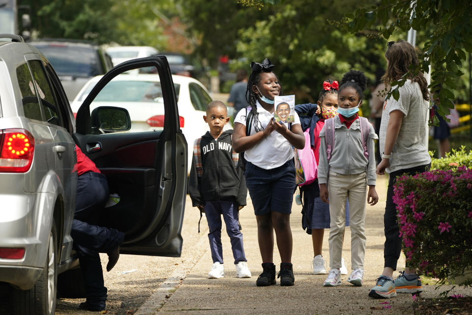 Spann Elementary School students are escorted to their parents' vehicles following a full day of in-school learning after having to again undertake virtual learning classes due to the city's water issues that forced Jackson Public Schools to close for several days, Tuesday, Sept. 6, 2022, in Jackson, Miss. (AP Photo/Rogelio V. Solis)