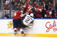 Florida Panthers center Sam Bennett (9) and Vegas Golden Knights defenseman Zach Whitecloud (2) go into the boards during the second period of an NHL hockey game, Thursday, Jan. 27, 2022, in Sunrise, Fla. (AP Photo/Lynne Sladky)