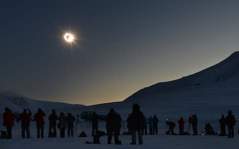 People watch a total solar eclipse from Longyearbyen, Svalbard, an archipelago administered by Norway in 2015.  - Credit: AFP