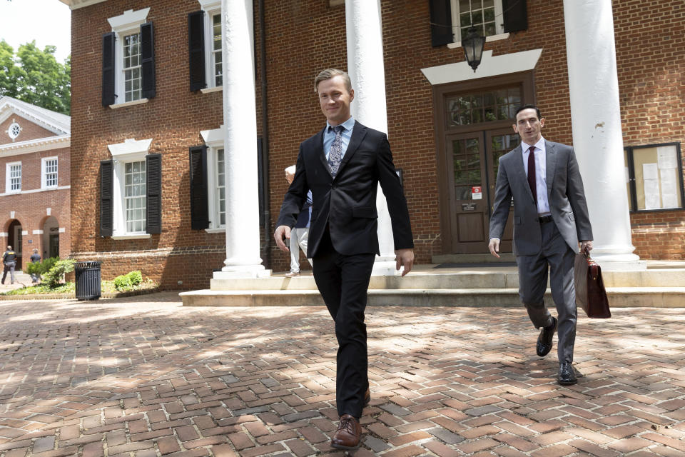 Jacob Joseph Dix and Peter Frazier exit the Albemarle County Circuit Court in Charlottesville, Va., Tuesday, June 4, 2024. The trial of Dix got underway with jury selection. The case will provide the first test of a 2002 Virginia law that makes it a felony to burn something to intimidate and cause fear of injury or death. Lawmakers passed the law after the state Supreme Court ruled that a cross-burning statute used to prosecute Ku Klux Klan members was unconstitutional. (AP Photo/Ryan M. Kelly)