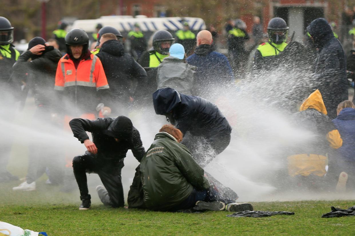 <p>Police in Amsterdam also used a water cannon to disperse protesters</p> (REUTERS)