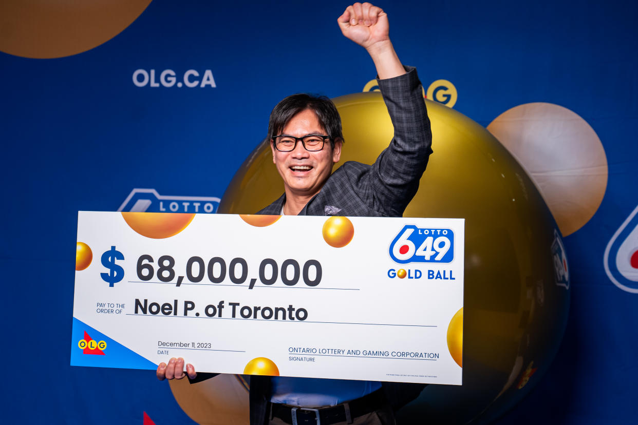 Man holding a $68 million cheque. 
