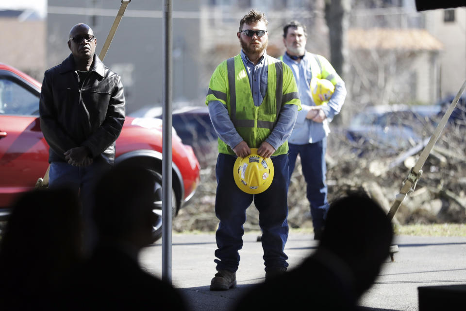 Electrical worker Kurt Chandler, center, listens during a worship service in a tent at Mount Bethel Missionary Baptist Church, Sunday, March 8, 2020, in Nashville, Tenn. The congregation held their Sunday service in a tent in the parking lot near the church facilities, which were heavily damaged by a tornado March 3. Chandler was repairing utility lines on the property. (AP Photo/Mark Humphrey)