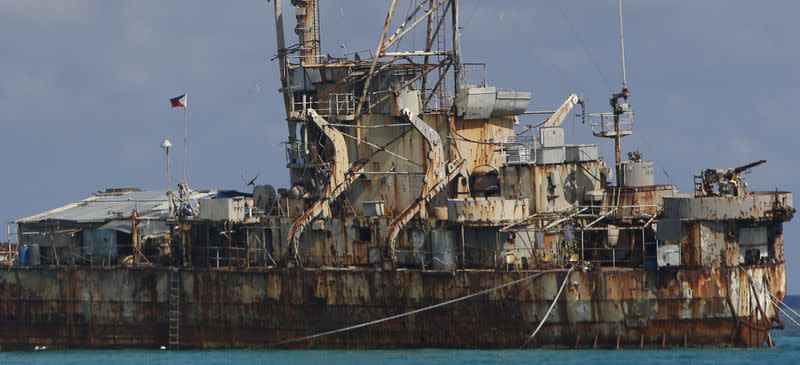 A Philippine flag flutters onboard the BRP Sierra Madre, a marooned transport ship which Philippine Marines used as a military outpost, in the disputed Second Thomas Shoal