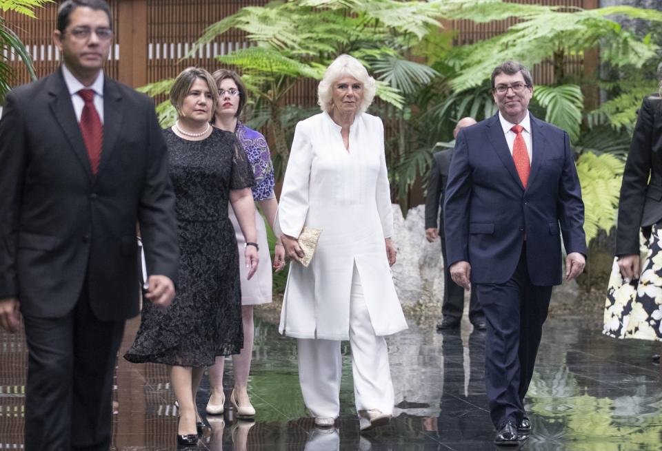 <p>For the couple's official welcome from Cuban President Miguel Diaz-Canal and his wife, Camilla wore a white caftan and wide legged pants with metallic wedges and a gold clutch. </p>