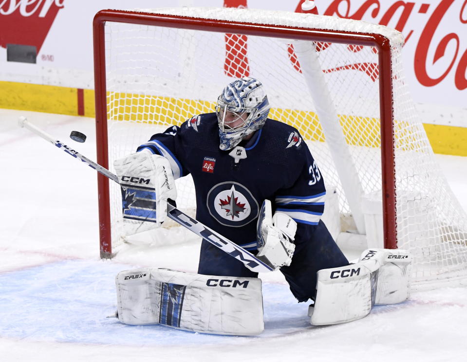 Winnipeg Jets goaltender David Rittich makes a save on an Ottawa Senators shot during the first period of an NHL hockey game Tuesday, Dec. 20, 2022, in Winnipeg, Manitoba. (Fred Greenslade/The Canadian Press via AP)