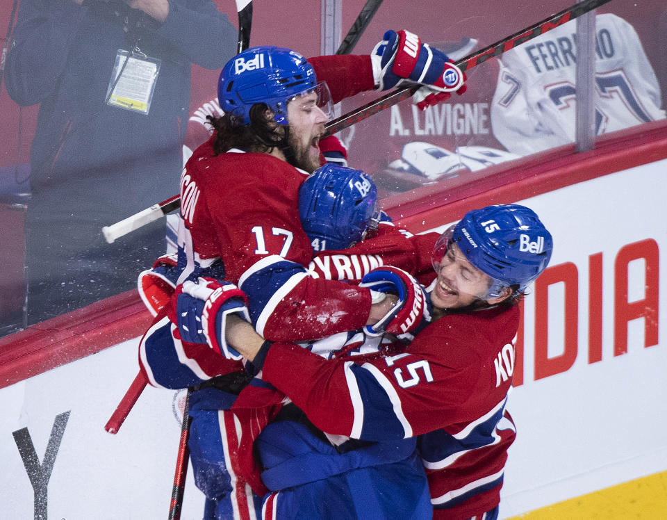 Montreal Canadiens' Josh Anderson (17) celebrates with teammates Paul Byron (41) and Jesperi Kotkaniemi (15) after scoring against the Vegas Golden Knights during overtime in Game 3 of an NHL hockey semifinal series, Friday, June 18, 2021, in Montreal. (Graham Hughes/The Canadian Press via AP)