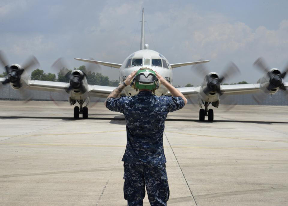 In this Monday, March 17, 2014 photo released by U.S. Navy, a sailor assigned to Patrol Squadron (VP) 46 prepares to launch a P-3C Orion before its mission to assist in search and rescue operations for Malaysia Airlines Flight 370 in Kuala Lumpur, Malaysia. New radar data from Thailand gave Malaysian investigators more potential clues Wednesday, March 19 for how to retrace the course of the missing Malaysian airliner, while a massive multinational search unfolded in an area the size of Australia. Cmdr. William Marks, a spokesman for the U.S. Navy's 7th Fleet, said finding the plane was like trying to locate a few people somewhere between New York and California. (AP Photo/U.S. Navy, Mass Communication Specialist 2nd Class Eric A. Pastor)