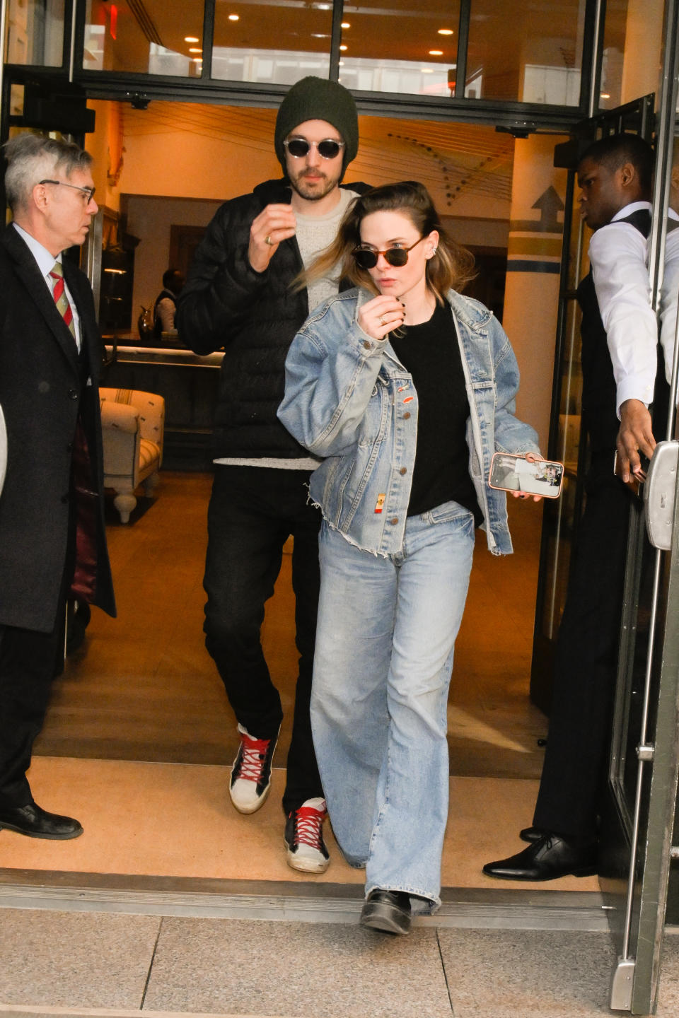 Rory St. Clair Gainer and Rebecca Ferguson exiting a building